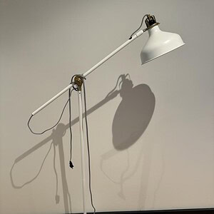 Adjustable white designer floor lamp with sleek modern design, perfect for home or office lighting.