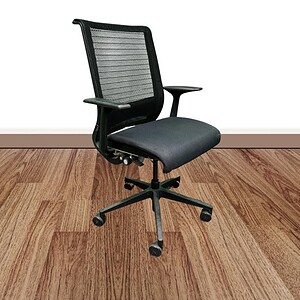 Ergonomic Steelcase Think black office chair with fixed arms on wooden floor.