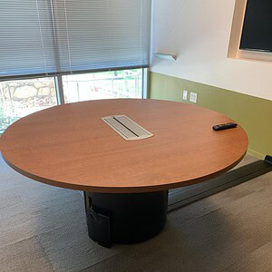Powered Cherry Conference Table with built-in outlets and sleek design.