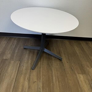 Gunmetal base with white 36-inch round tabletop by Knoll Studio, ideal for contemporary office or di.