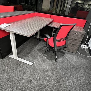 Modern office corner with Cube World USA furniture and red accents.