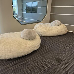 Soft white plush furry XXL bean bags ideal for relaxing and lounge areas.
