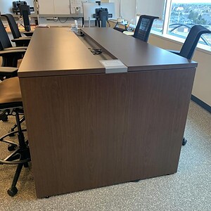 Modern Steelcase 8x4 bar height island with power outlets in office setting.