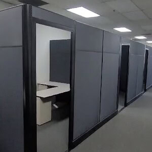 Private office cubicle with tall doors for workspace privacy and sound insulation.