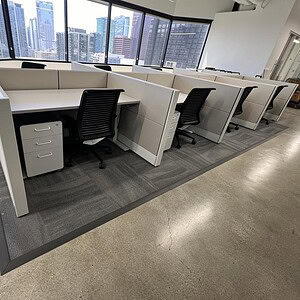 Modern office cubicles with Herman Miller Ethospace Sage desks in a high-rise setting.