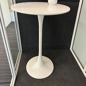 White bar height table with tulip-style pedestal base for modern commercial or residential spaces.