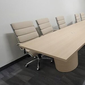 Modern 14x4ft boat-shaped conference table for corporate meetings.