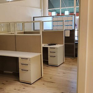 Modern Haworth Compose 65-inch T quarter glass office workspace.