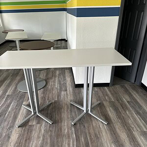 Herman Miller 6ft bar height table for versatile office and lounge spaces. Durable, modern design pe.