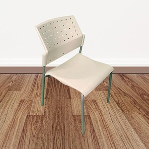 White stackable chair with perforated backrest, ideal for office or meeting spaces.