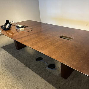OFS Espresso 10x4.5 ft table featuring built-in power outlets, ideal for office or conference room s.