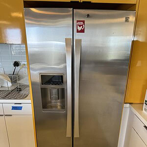Stainless steel Kenmore Elite refrigerator with ice maker, perfect for modern kitchens. Durable, sty.