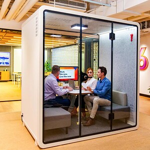 Privacy pod with glass doors for focused meetings and collaboration. Ideal for modern office environ.