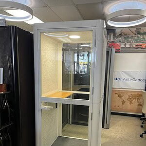 Privacy pod for office or healthcare use, compact and modern design.