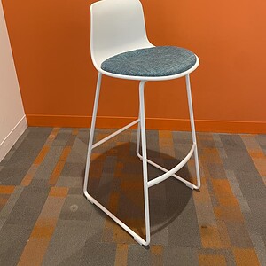 Enea Lottus bar stool with sled base, white frame, and cushioned seat for modern office or lounge ar.