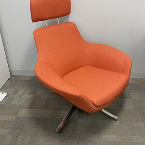 Office chair with orange fabric and adjustable headrest for ergonomic comfort.