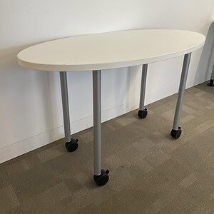 Oval Steelcase white table on casters, ideal for flexible workspace arrangements.