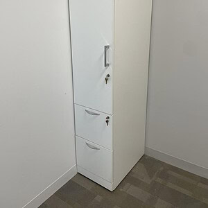 Steelcase white storage locker with lock and multiple compartments for secure organization.