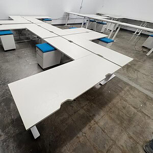 Adjustable white desks for ergonomic workspace solutions.