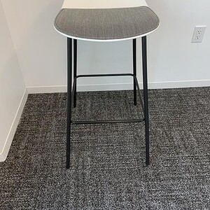Modern Allermuir grey bar stool with cushioned seat and black metal legs.