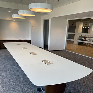 Frosted glass conference table in a modern office setting, ideal for meetings and collaborative work.