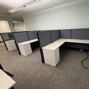 Modern office cubicles with Herman Miller A02 desks in various colors.