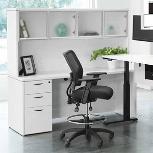 Shaped desk with integrated storage and workspace in modern office setting.