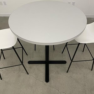 Black base 3ft bar table with sleek white surface, ideal for commercial or home bar setups.
