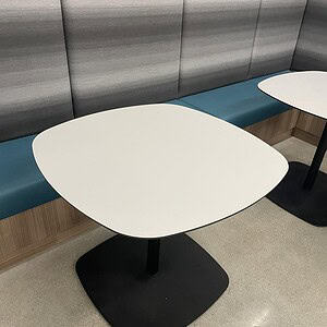 Contemporary 3ft oval office table with sleek white top and black base.