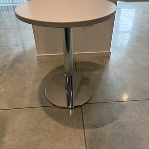White and chrome 30-inch round occasional table for modern living spaces.