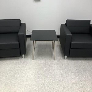 Versatile black or white OFS occasional table with sleek design, perfect for modern office or lounge.