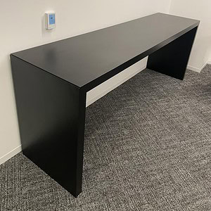 Black rectangular table ideal for meetings or workspace environments.