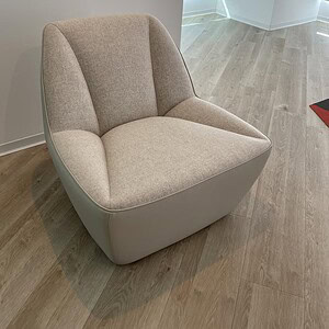Ivory swivel lounge chair with plush upholstery, perfect for modern living spaces.