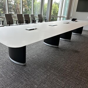 Modern Knoll glass boat conference table in black and white, ideal for corporate meeting rooms.