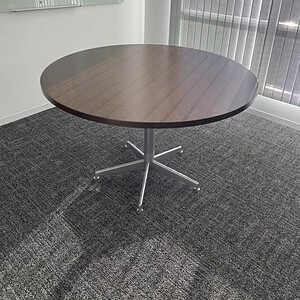 Elegant 48-inch espresso wood table with a sleek 5-star base, perfect for modern office or conferenc.