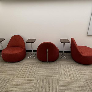 Red low egg chair with casters for versatile seating solutions.
