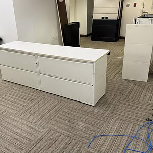 Modern white credenza with top, ideal for office storage and decor.