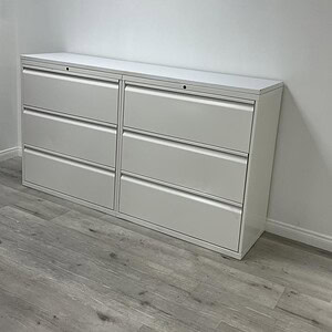 Three drawer lateral file cabinet for office storage and organization.