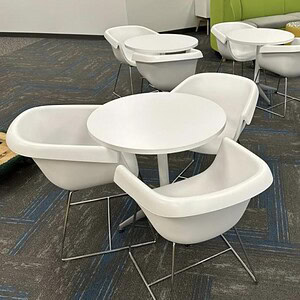 White modern sled base chairs with rounded seats and metal legs, ideal for office or lounge areas.