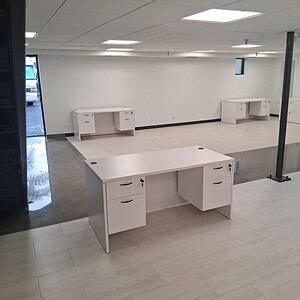 Double white office desk with double pedestal, ideal for modern workspaces.