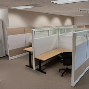 Office cubicles with glass panels and beige accents for modern workspace efficiency.