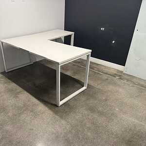 Herman Miller white desk, 5.5x5.5ft, 30-inch depth, ideal for office spaces.