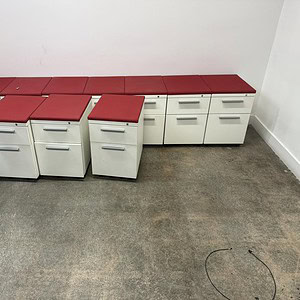 Herman Miller white mobile ped desk with red top, versatile office storage solution.