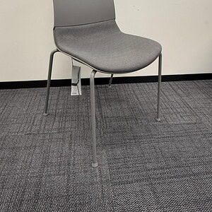 Grey guest chair with cushioned seat and backrest, ideal for waiting areas or conference rooms.