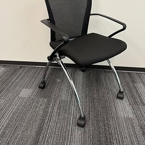 Black Haworth X99 nesting chair for office or conference room. Ergonomic design with mesh back and c.