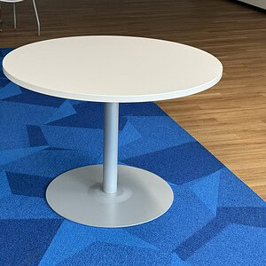 Haworth steel base & 42in round white top table, ideal for office or conference room settings.