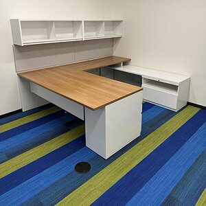 Office desk with white and wood finish, ideal for professional workspaces.