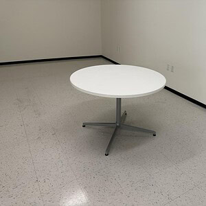 Round Haworth X Base 42-inch table with various tops for versatile office or conference room use.