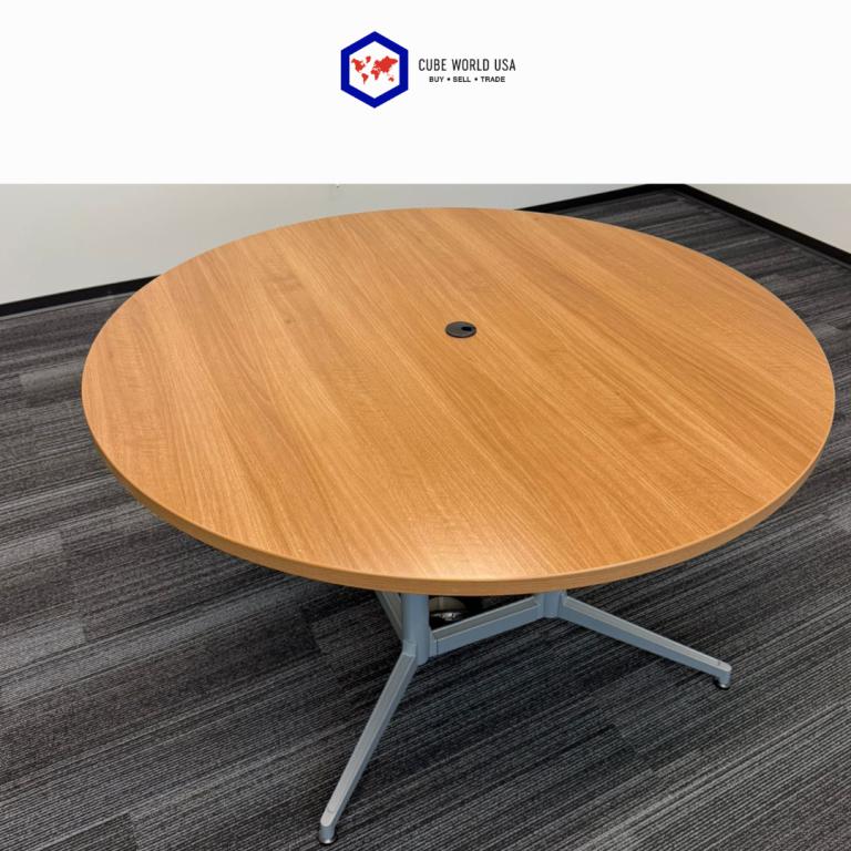 Haworth 54-inch round table featuring a maple wood top and sleek silver base, ideal for modern offic.