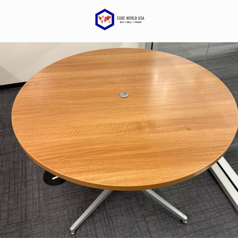 Round conference table with maple top and silver base, ideal for meetings.